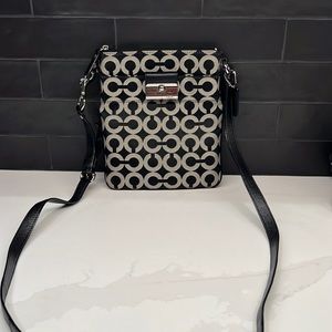 Coach cross body purse in modern coach designed fabric.